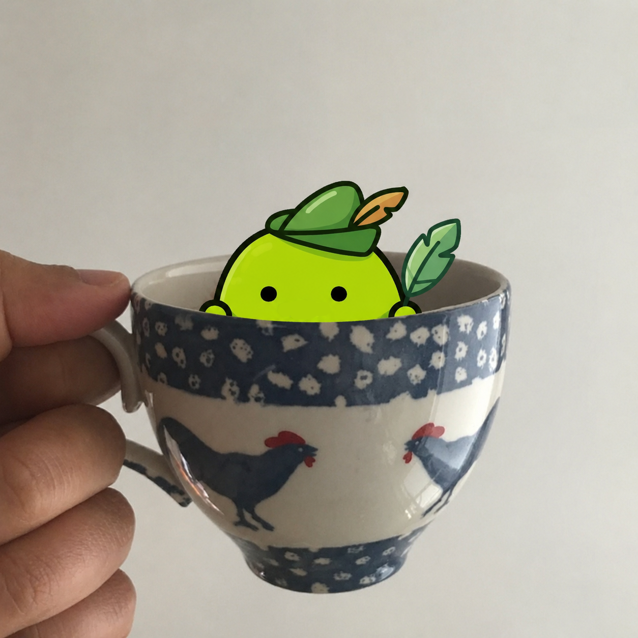 Lunchy peeking out of a chicken teacup